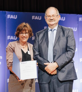 Der Dekan der Naturwissenschaftlichen Fakultät, Prof. Dr. Schatz überreicht den FAU-Preis für Promotionsbetreuung 2025 an Prof. Dr. Jutta Eichler (Bildrechte: FAU/Iannicelli)